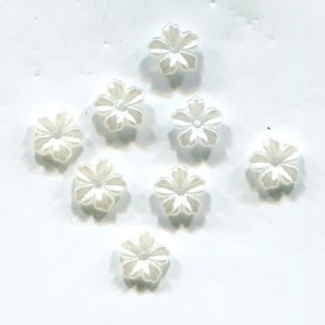 May include: Ten white pearl flower-shaped buttons with a hole in the center.