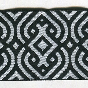 May include: Black and white patterned fabric with a geometric design. The fabric has a woven texture.