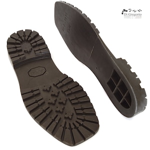 May include: A pair of brown rubber shoe soles with a textured tread pattern. The sole on the left has the text "MADE IN ITALY" and the sole on the right has the text "MT-1136 045/40".