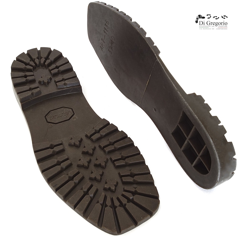 May include: A pair of brown rubber shoe soles with a textured tread pattern. The sole on the left has the text "MADE IN ITALY" and the sole on the right has the text "MT-1136 045/40".