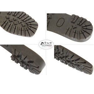 May include: Close-up view of the bottom of a brown leather boot. The sole is made of a textured rubber with a Vibram logo. The boot has a lug pattern for traction.