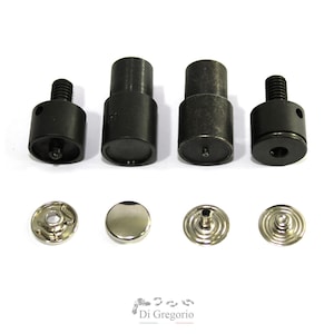 May include: Set of four black metal snap pliers and four silver metal snaps. The snaps are in different sizes and styles.
