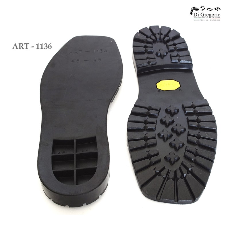 May include: Two black rubber shoe soles, one with a textured tread pattern and the other with a smooth surface and a grid pattern. The sole with the tread pattern has a yellow patch on the heel. The text "ART - 1136" is printed on the image.