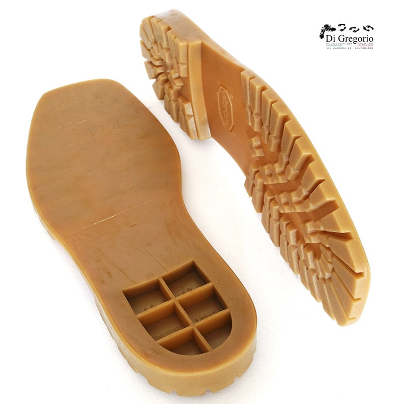 May include: A pair of brown rubber shoe soles with a textured tread pattern. One sole has a grid pattern on the inside.