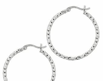 May include: A pair of silver hoop earrings with a textured diamond pattern.