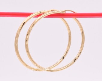 thumbnail interactive-video image 1 of 14K Yellow Gold Large 30mm Diamond Cut Shiny Hoop Earrings - Made In Italy 1 of 3