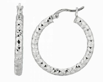 May include: A pair of silver hoop earrings with a textured diamond pattern.