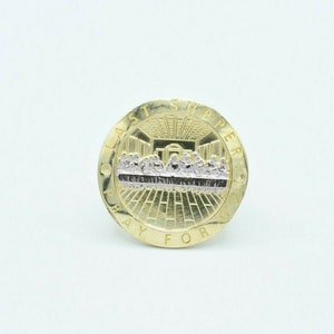 May include: Gold-toned round pendant with a depiction of the Last Supper in the center. The pendant is inscribed with the words "Last Supper Pray For Us".