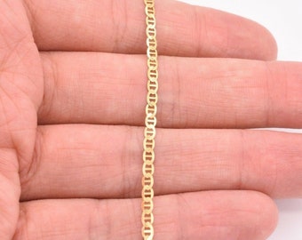 May include: A gold mariner chain necklace. The chain is made of solid gold and has a classic mariner link design.