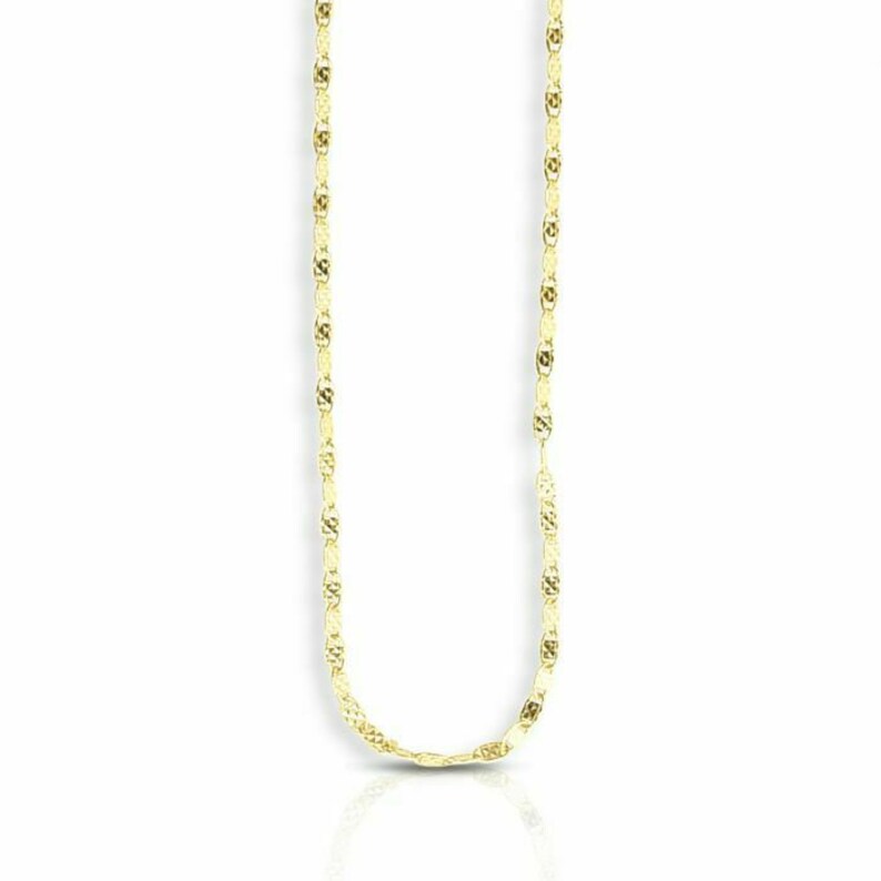 May include: A gold chain necklace with a delicate, textured design. The chain is made of small, oval-shaped links.