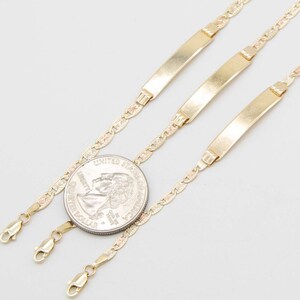 May include: Three gold chain bracelets with a delicate, patterned design. Each bracelet features a flat, rectangular tag.
