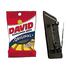 May include: A red, white, and yellow bag of David sunflower seeds with the text "Original" and "Eat, Spit, Be Happy!" printed on the front.