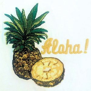 May include: Embroidered pineapple design with the word "Aloha!" in yellow thread on a white background.