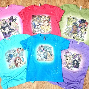 May include: Six different t-shirts with bleach-splattered designs featuring Disney princesses and villains. The shirts are in various colours, including pink, red, green, blue, and purple.