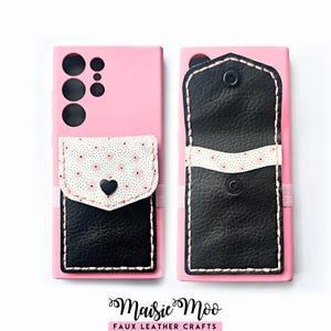 May include: A pink smartphone case featuring a black and white floral patterned pocket with a black heart-shaped snap closure, alongside a black faux leather wallet attachment with a snap button. The text Maisie Moo Faux Leather Crafts is below.
