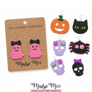 May include: A collection of Halloween-themed faux leather earrings featuring a pair of pink ghosts with black bows on a display card labeled HALLOWEEN EARRINGS Maisie Moo, plus individual pumpkin, cat, skull, and spider designs with metal hooks.