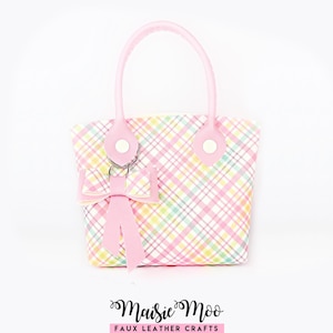 May include: A small handbag featuring a pastel plaid pattern in pink, yellow, green, and white. The bag has two pink handles attached with white circular accents and a matching pink bow charm hanging from a silver ring. The text Maisie Moo Faux Leather Crafts is visible below.
