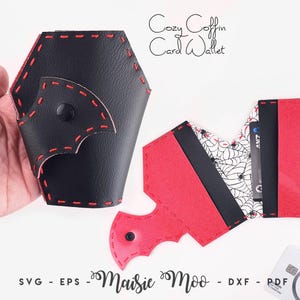 May include: A coffin-shaped card wallet featuring black exterior panels with red stitching and a black snap closure. The interior displays a white fabric lining with a black spiderweb pattern, red accents, and black card slots. Text reads Cozy Coffin Card Wallet.