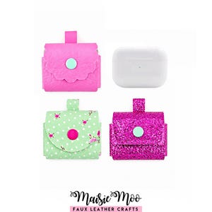 May include: Three small square pouches with top flaps and snap closures, including one solid hot pink, one light green with a floral pattern, and one glittery dark pink pouch, alongside a white rectangular wireless earbud charging case.