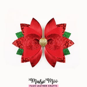 May include: A multi-layered hair bow featuring red faux leather petals, red glitter accents, and green glitter leaves. The centre is adorned with a circular gold glitter embellishment. The text Maisie Moo Faux Leather Crafts is printed below.