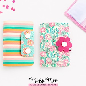 May include: Two rectangular faux leather organizers with snap closures. The left organizer features horizontal stripes in peach, teal, and cream with a floral flap. The right organizer has a cactus and succulent print with a pink flower-shaped snap.