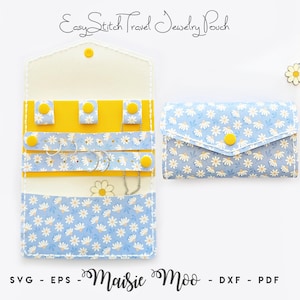 May include: A travel jewelry pouch featuring a blue and white daisy pattern with yellow snap closures. The open pouch displays internal yellow tabs and straps for organizing accessories, while the closed pouch shows the exterior floral design.