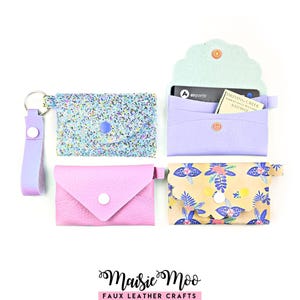 May include: Four small rectangular pouches with snap closures. One has a blue glitter finish and a wrist strap. One is solid lavender, one is solid pink, and one features a floral pattern on a tan background. Text reads Maisie Moo Faux Leather Crafts.