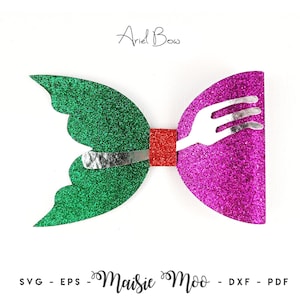 May include: A glittery bow featuring a green scalloped side and a magenta side, joined by a red center square. A silver fork graphic is layered across the center. The text Ariel Bow appears above, and Maisie Moo SVG - EPS - DXF - PDF below.