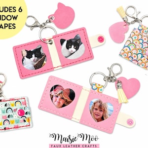 May include: A set of foldable faux leather keychains featuring various patterns and solid pink accents. Each keychain includes a metal ring, a pink heart or cat-shaped charm, and windows for photos. Text on the image reads INCLUDES 6 WINDOW SHAPES.