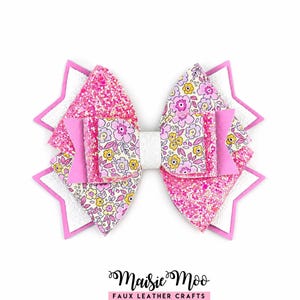 May include: A multi-layered hair bow featuring pink glitter, white, and floral patterned sections with yellow and pink flowers. The bow has a star-shaped base and a central white band. The text Maisie Moo Faux Leather Crafts is below.