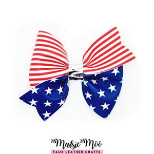May include: A decorative bow featuring a top section with red and white horizontal stripes and a bottom section with a blue background and white stars. The two sections are joined in the centre by a shiny silver metallic band. The text Maisie Moo FAUX LEATHER CRAFTS is printed below the bow.