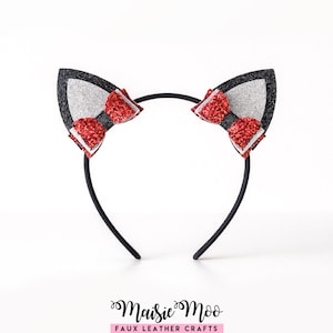 May include: A black headband featuring cat ears. The ears are black with silver glitter and red glitter bows. A playful accessory for fancy dress or daily use.