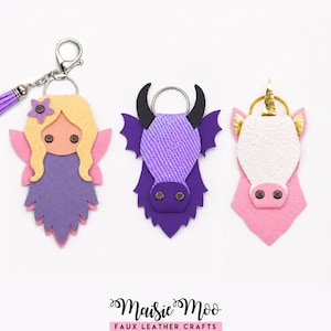 May include: Three keychains featuring a fairy with blonde hair and a purple tassel, a purple dragon with black horns, and a white unicorn with a gold horn. Each keychain has a metal ring and is labeled with the text Maisie Moo Faux Leather Crafts.