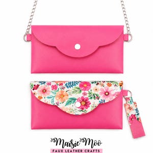 May include: Two pink faux leather clutches. One has a silver chain strap. The other has a floral flap and a matching keychain. Both have a silver snap closure. The bottom clutch has a floral pattern with pink, orange, and green flowers.