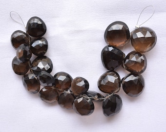 May include: A strand of dark brown faceted gemstone beads, strung on a thin wire. The beads are heart-shaped and have a smooth, polished finish.