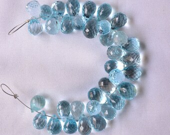 May include: A strand of light blue teardrop-shaped gemstone beads strung on a silver wire.