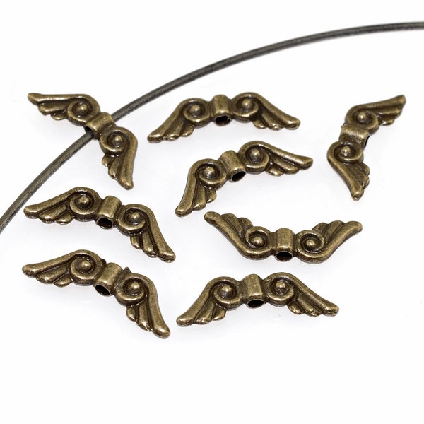 0,18 EUR/pc. 10 small angel wings in antique bronze color