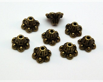 0,12 EUR/pc. 20 bead caps in antique bronze, 9 mm