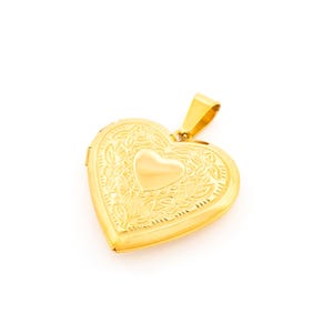 May include: A gold heart-shaped locket with an intricate floral design. The locket has a smaller heart-shaped opening in the center.