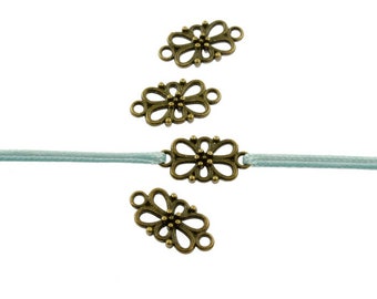 0,19 EUR/pièce. 12 connecteurs filigranes "Fleur" de couleur bronze antique