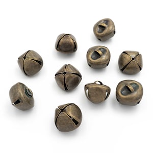 May include: A collection of ten antique gold-toned jingle bells. The bells are small and have a rounded shape with a small hole at the top for hanging.