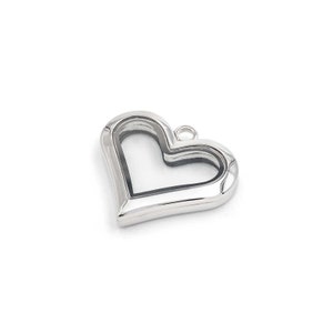 May include: Silver heart-shaped locket with a clear glass insert. The locket has a small loop at the top for attaching a chain.
