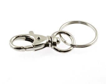 1.34 EUR/piece 2 sturdy snap hooks with swivel coupling and key ring in silver