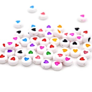 0,04 EUR/pc. Acrylic beads with colorful hearts in white 50 pieces