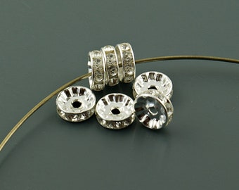 0.24 EUR/pc. 10 spacer beads with rhinestones in silver