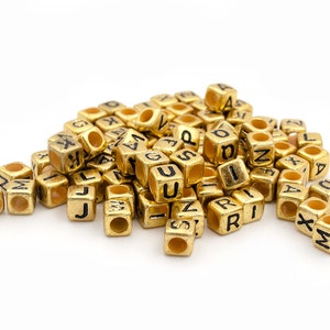 0.03 EUR/piece Vintageparts DIY cube-shaped letter beads made of acrylic in gold, 100 pieces