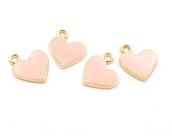 Heart-shaped pendants with pink enamel in light gold color, 4 pieces