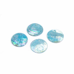 May include: Four iridescent blue round sequins with a hole in the centre.