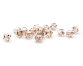 0,07 EUR/pièce. Vintageparts DIY perles de verre coupées en toupies en beige 6 mm 40 pièces