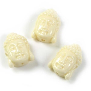1.15 EUR/piece. Bead as head of Buddha made of synthetic coral in white, 2 pieces